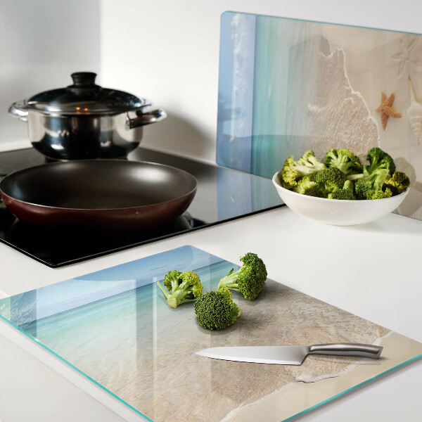 Snijplanken glas Strand met schelpen en golven