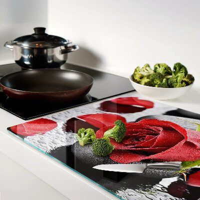 Szklana deska kuchenna Róża na kamieniach z kroplami wody