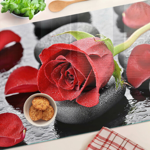 Szklana deska kuchenna Róża na kamieniach z kroplami wody