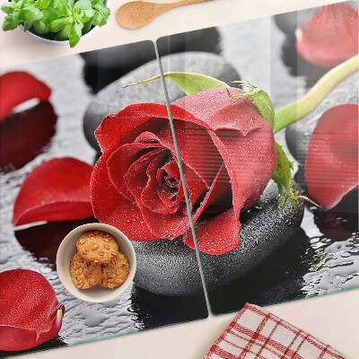 Szklana deska kuchenna Róża na kamieniach z kroplami wody