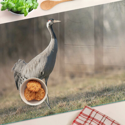 Glazen snijplanken Een kraan tegen de achtergrond van een landschap.