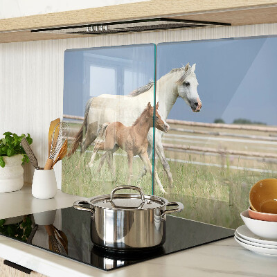 Glazen snijplanken Een paard met een veulen in een weiland.