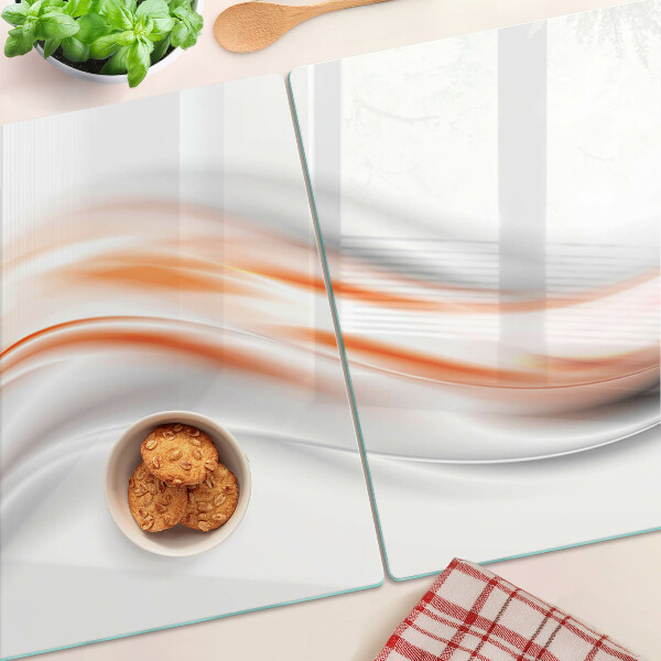 Snijplanken glas Golven in tinten oranje en grijs.
