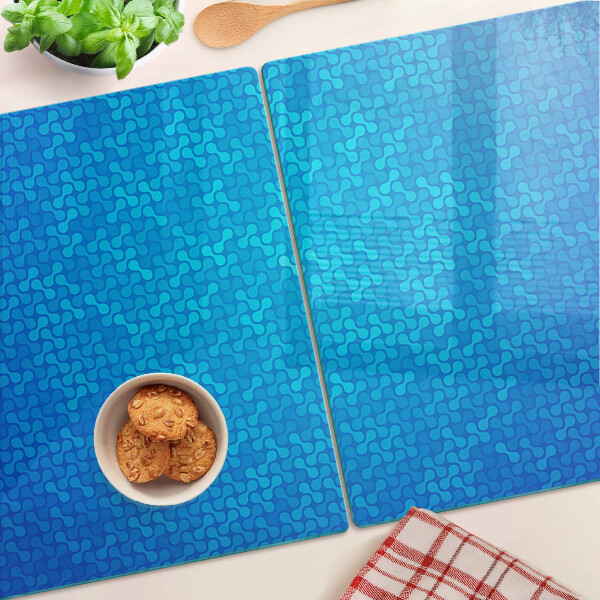 Snijplanken van glas Een golvend patroon in verschillende blauwtinten.