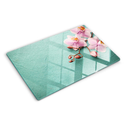 Snijplanken van glas Orchideeën op een blauwe achtergrond