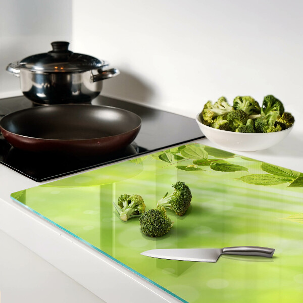 Szklana deska do krojenia Zielone liście na tle światła