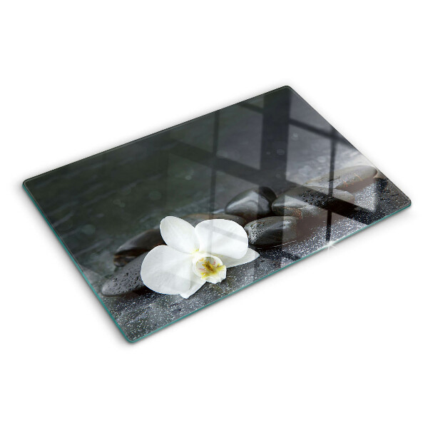 Snijplanken glas Orchideebloem op stenen