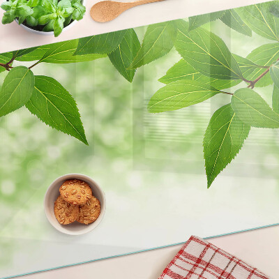 Szklana deska kuchenna Liście na tle rozmytej zieleni