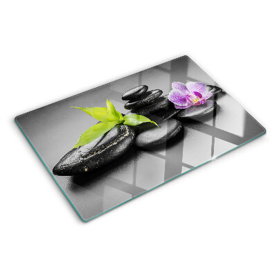 Glazen snijplanken Stenen en orchidee op de achtergrond