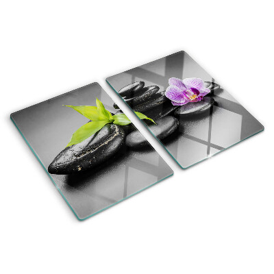 Glazen snijplanken Stenen en orchidee op de achtergrond