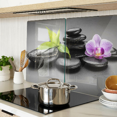 Glazen snijplanken Stenen en orchidee op de achtergrond