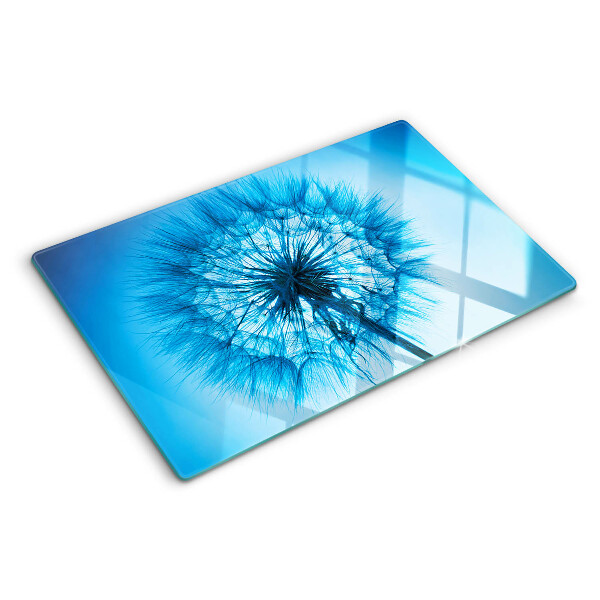 Snijplanken van glas Paardenbloem op een blauwe achtergrond