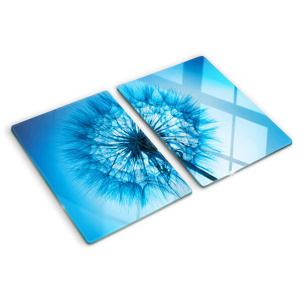 Snijplanken van glas Paardenbloem op een blauwe achtergrond