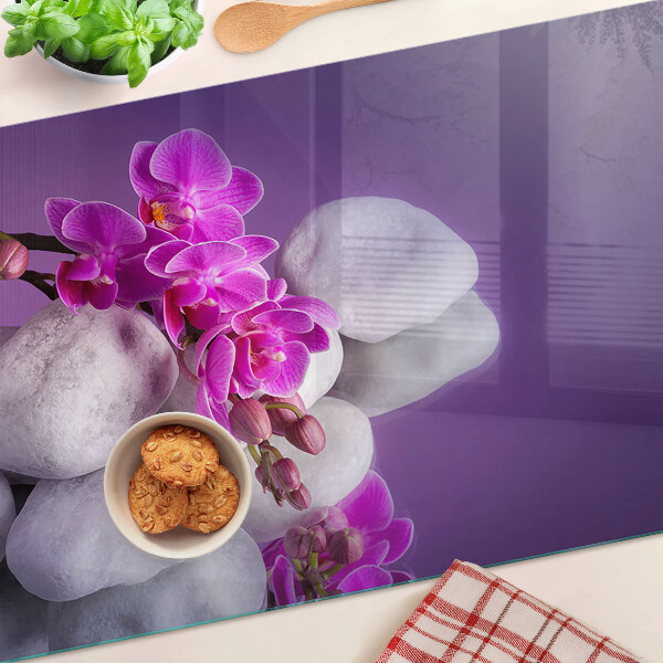Deska kuchenna szklana Kwiaty orchidei na tle kamieni