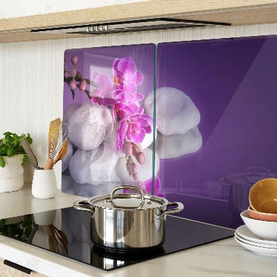Deska kuchenna szklana Kwiaty orchidei na tle kamieni