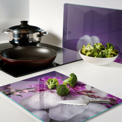 Deska kuchenna szklana Kwiaty orchidei na tle kamieni