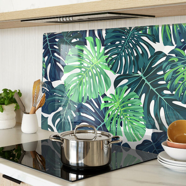 Glazen snijplanken Monstera-bladeren op een tropische achtergrond
