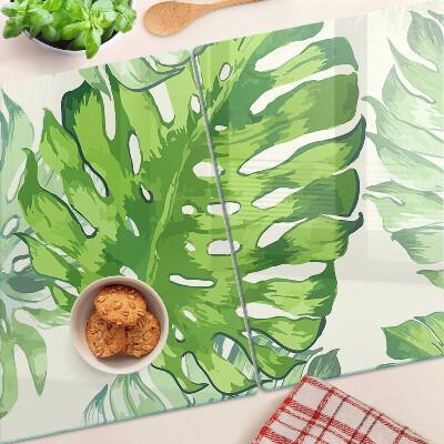 Snijplanken glas Monstera-bladeren op een lichte achtergrond