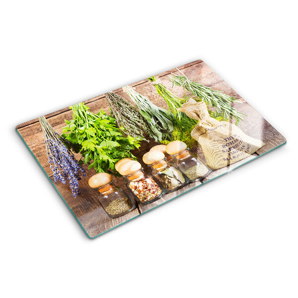 Szklana deska do krojenia Zioła i przyprawy na tle drewna