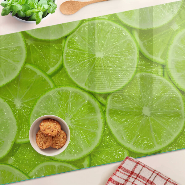 Szklana deska kuchenna Plastry limonki na zielonym tle