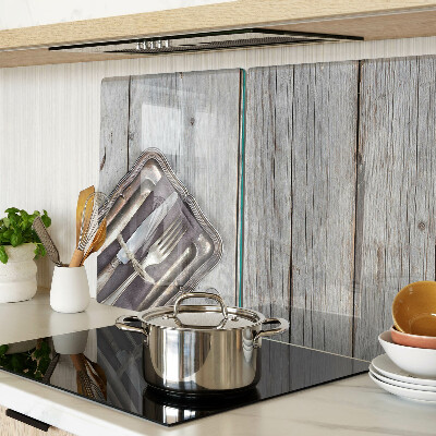 Snijplanken van glas Rustiek bestek op een houten achtergrond