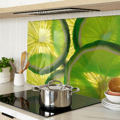 Szklana deska do krojenia Plastry limonki na zielonym tle