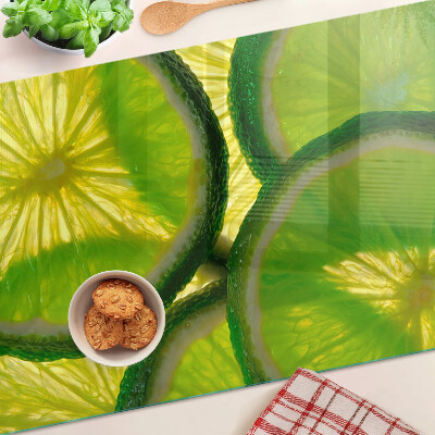 Szklana deska do krojenia Plastry limonki na zielonym tle