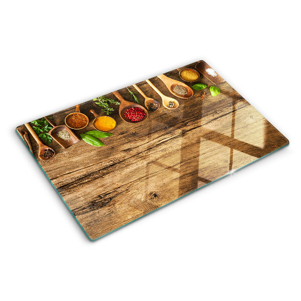 Snijplanken glas Specerijen en kruiden op een houten achtergrond