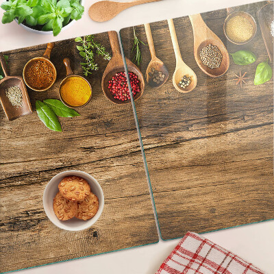 Szklana deska do krojenia Przyprawy i zioła na drewnianym tle