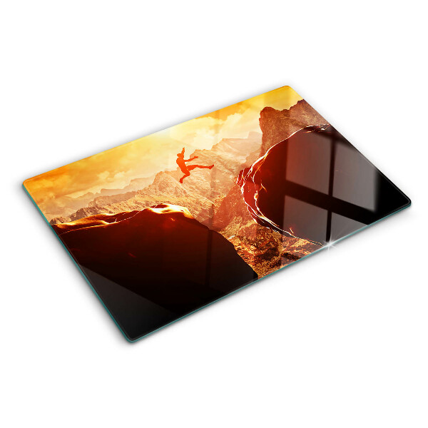Szklana deska kuchenna Skok w górach przy zachodzie słońca