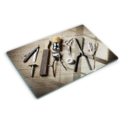 Snijplanken van glas Kappersgereedschap op een houten achtergrond