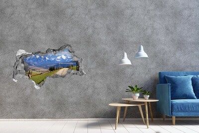 Zelfklevende 3D wandsticker illusie Berglandschap achter het gat in de muur
