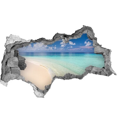 3D sticker gat in stenen muur Een paradijselijk strand met turquoise water.