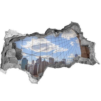 3D sticker gat in stenen muur Uitzicht op de stad door een gat in de muur.