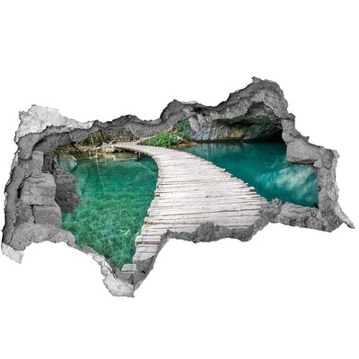 Dziura 3d w ścianie naklejka Tajemniczy most nad turkusową wodą