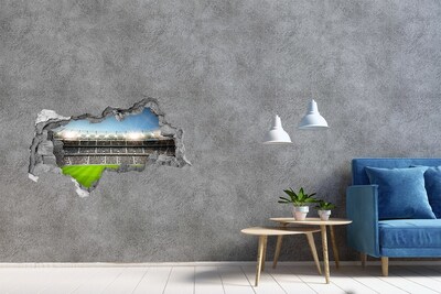 3D sticker gat in stenen muur Het voetbalstadion in actie.
