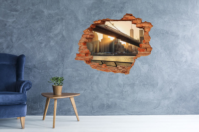 Vinyl muursticker 3D breekeffect Een beschadigde muur die uitkijkt op een betonnen ruimte.