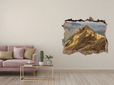 Zelfklevende 3D wandsticker illusie Berglandschap door een gat in de muur