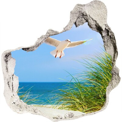 3D muursticker effect gat in de muur Uitzicht op het strand met een zeemeeuw.
