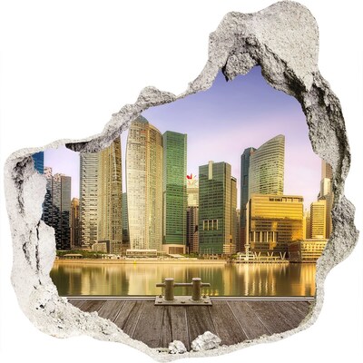 3D wandsticker gat in de muur Een uitzicht op een moderne stad aan het water.