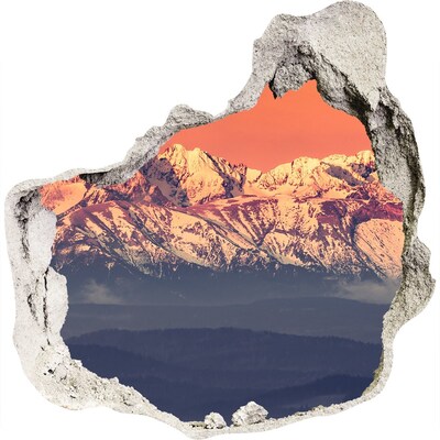 3D muursticker effect gat in de muur Bergen in de gloed van de zonsondergang