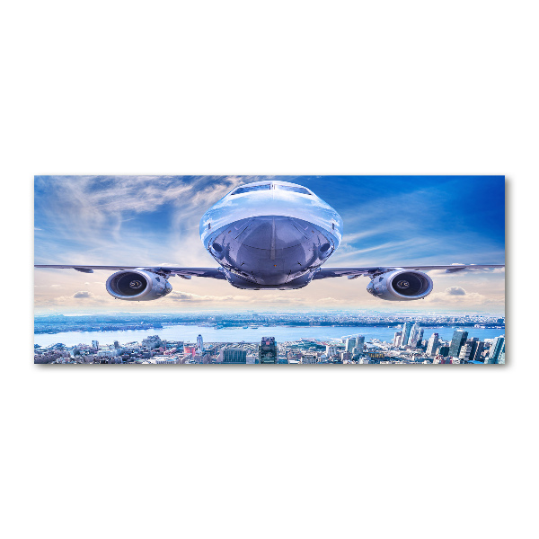 Foto in plexiglas Een vliegtuig boven de stad