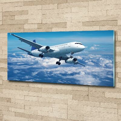 Foto in plexiglas Een vliegtuig in de wolken