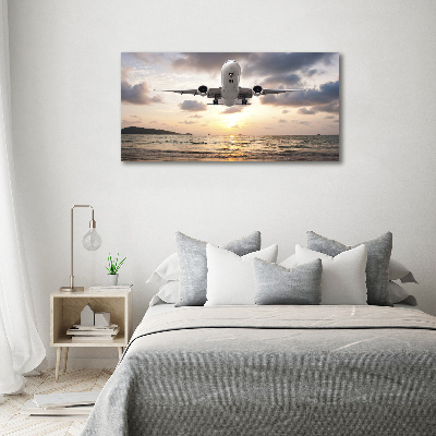 Schilderij op canvas Een vliegtuig boven de zee