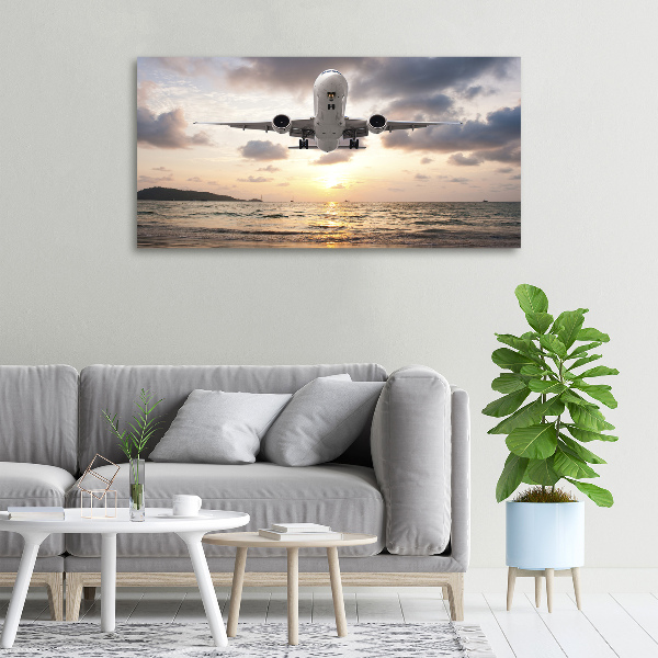 Schilderij op canvas Een vliegtuig boven de zee