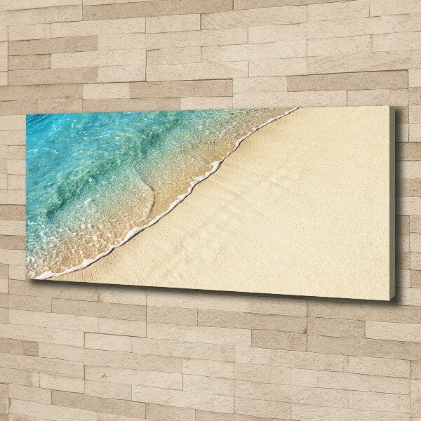 Foto canvas Een golf op het strand