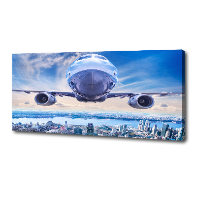 Schilderij op canvas Een vliegtuig boven de stad