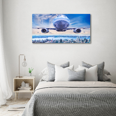 Schilderij op canvas Een vliegtuig boven de stad
