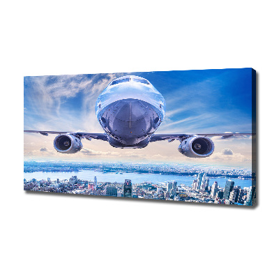 Schilderij op canvas Een vliegtuig boven de stad