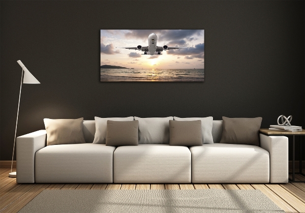 Foto schilderij op glas Een vliegtuig boven de zee